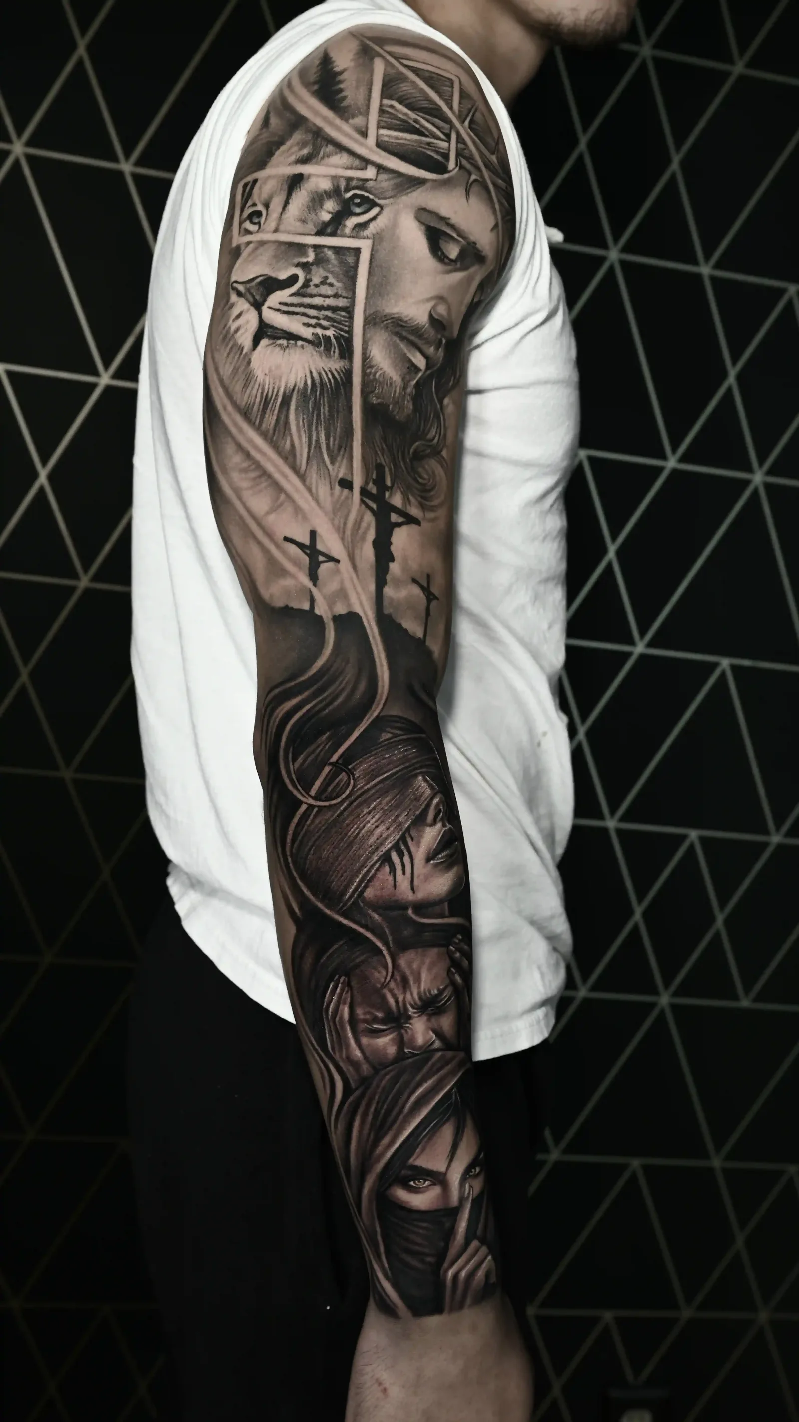 Black and grey full sleeve combining a lion portrait and Madonna religious imagery by Danyi at Shadow Studio Charlotte
