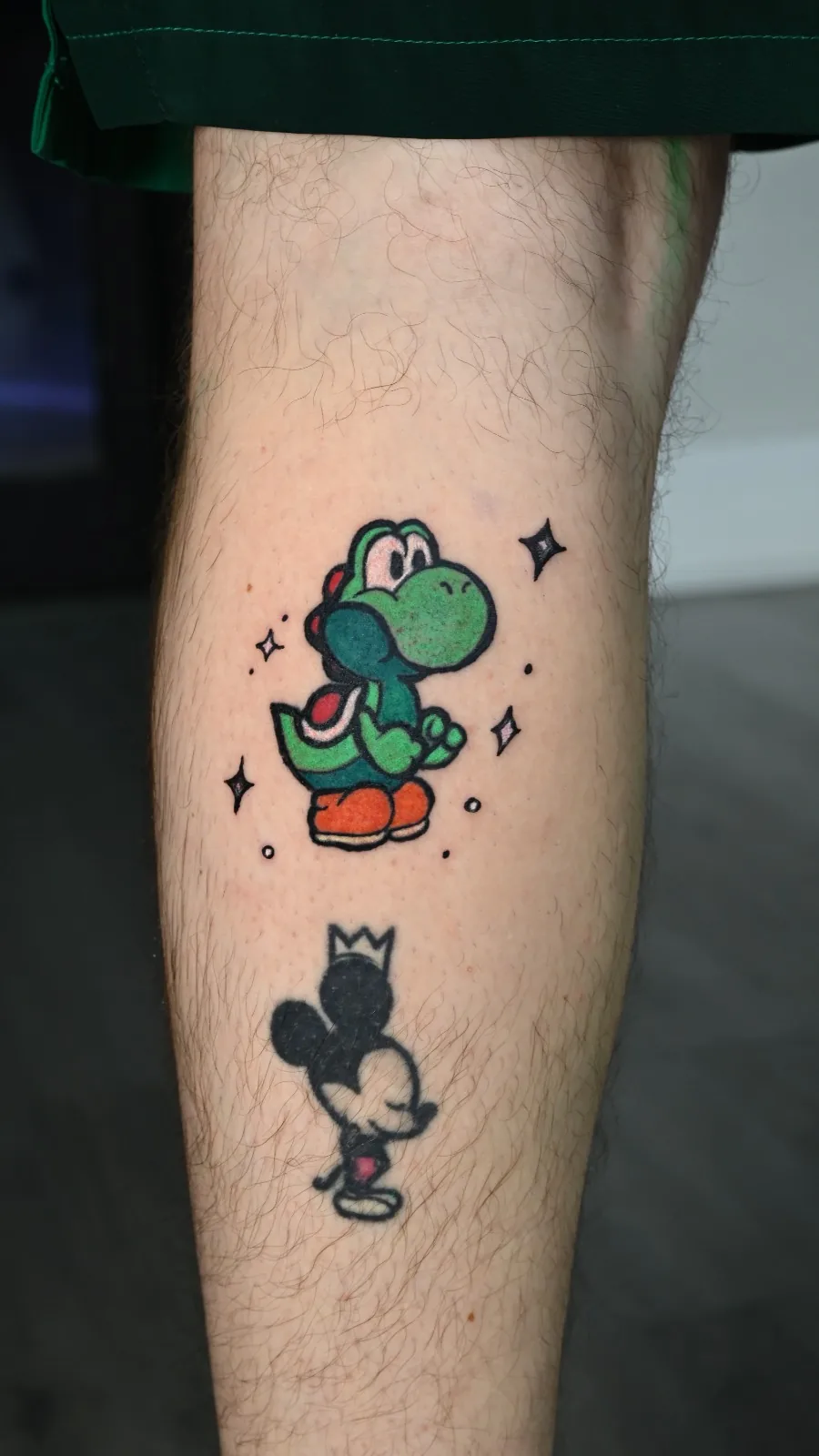 Color cartoon calf tattoo of Yoshi and Mickey Mouse by Inked Bites at Shadow Studio Charlotte