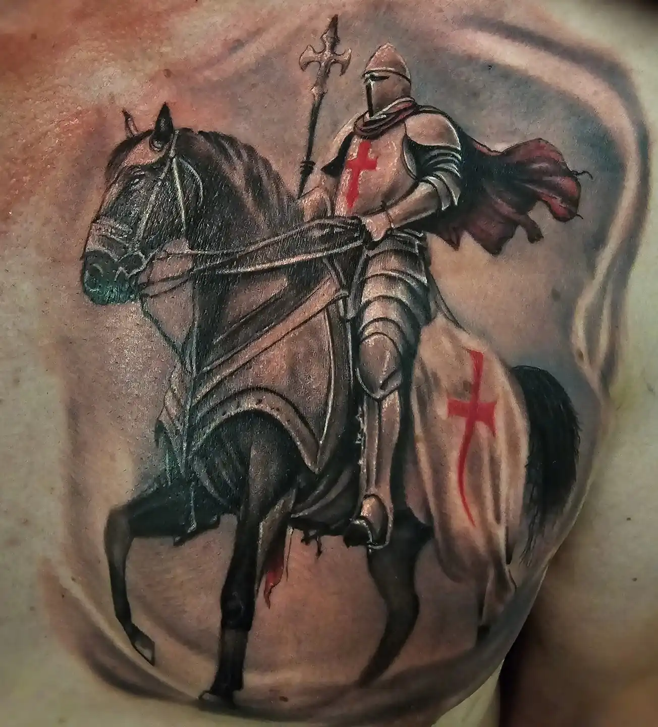 Color neo-traditional chest piece of a crusader knight on horseback with red cross by Joel at Shadow Studio Charlotte
