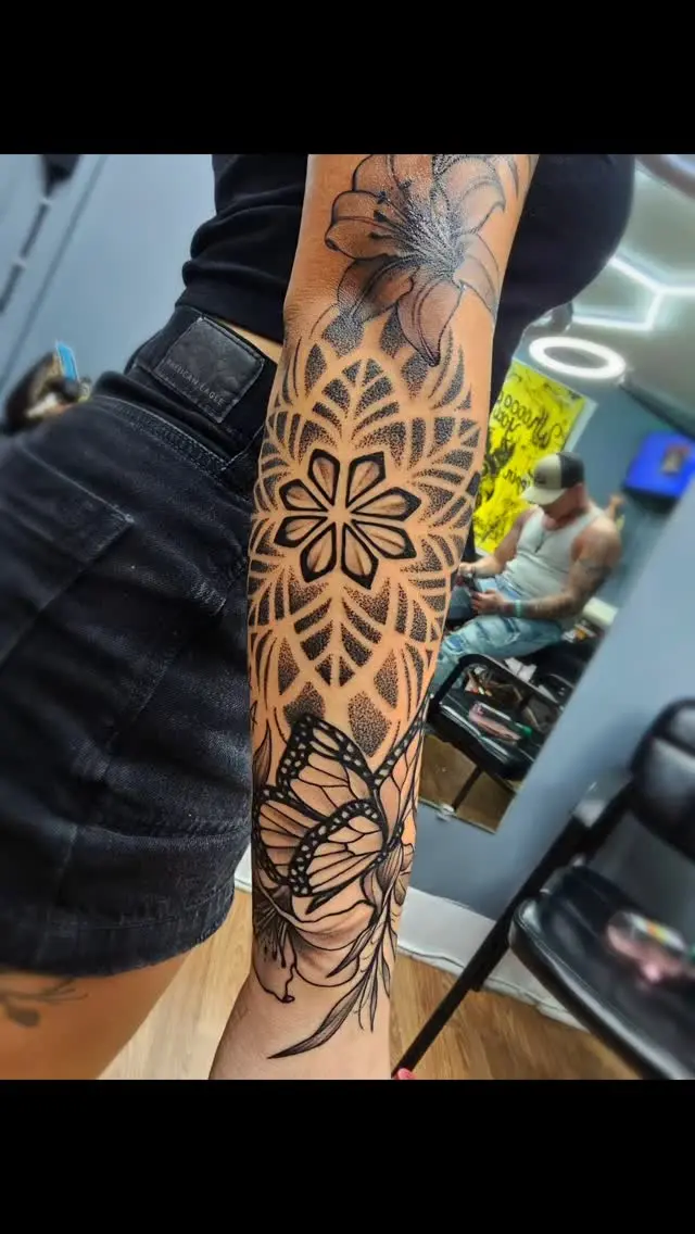 Black and grey neo-traditional mandala forearm sleeve with floral and dotwork details by Joel at Shadow Studio Charlotte