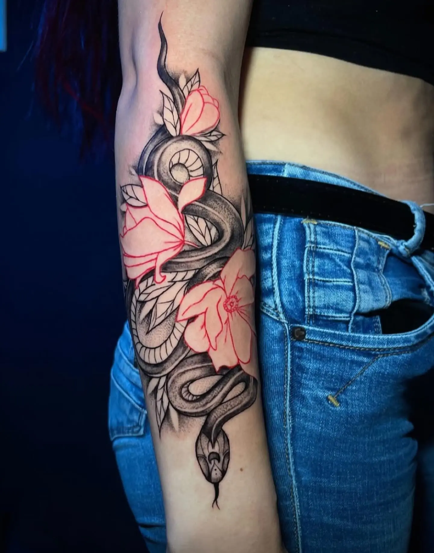 Black and grey snake and pink cherry-blossom forearm tattoo by Venus at Shadow Studio Charlotte